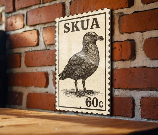 A wooden table with a wooden frame, and a framed image of a bird, which appears to be a postage stamp.