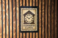 a clock with the words "FARMHOUSE CLOCK" written on it, mounted on a wooden wall.
