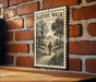 A vintage-style metal sign with the text "NATURE WALK" is mounted on a brick wall, featuring an illustration of a person walking on a path through a natural landscape.