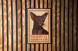 a poster of an Oriental Shorthair cat, which is mounted on a wooden wall.