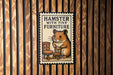 A sign with a hamster sitting on a chair, surrounded by a wooden background.