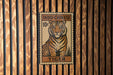 A vintage-style stamp featuring a tiger on a wooden background.