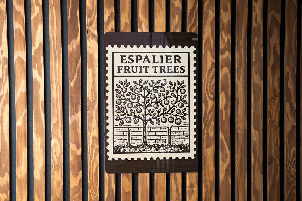 a sign with the text "ESPAALIER FRUIT TREES" and an illustration of a tree with fruit on a wall.