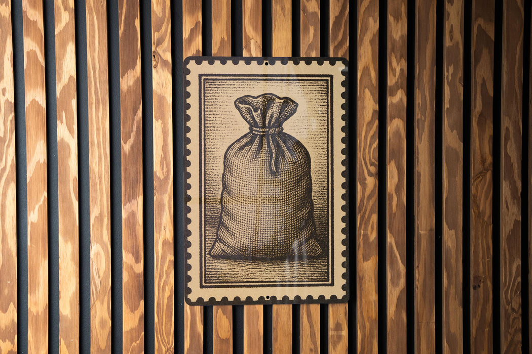 a wooden wall with a framed illustration of a bag, which appears to be a postage stamp-like design.