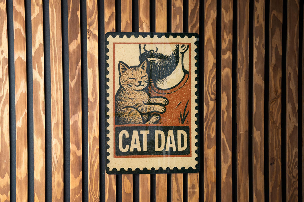 A metal sign with a cat and a man's face, mounted on a wooden wall.