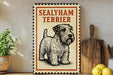 A metal sign with a drawing of a Sealyham Terrier dog, placed on a wooden surface next to a wooden cutting board and some lemons.