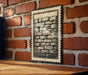 a brick wall with a framed drawing of a brick wall on it, mounted on the wall.