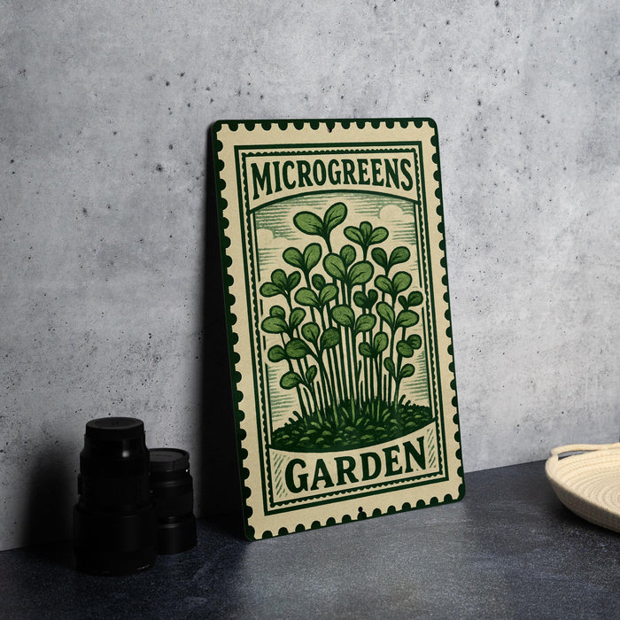 a metal sign with a green and white design, displaying the text "MICROGREENS GARDEN" and an illustration of a plant.