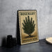 A metal sign with a rosemary bush illustration and the text "ROSEMARY BUSH" is displayed on a table.
