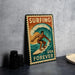 A vintage-style metal sign with a surfer riding a wave, accompanied by the text "Surfing USA Forever".