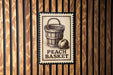 A wooden wall with a metal sign featuring an illustration of a peach basket and the text "PEACH BASKET" printed on it.