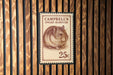 A 25c postage stamp featuring a hamster illustration.