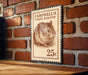 A 25c postage stamp featuring a hamster on a brick wall.