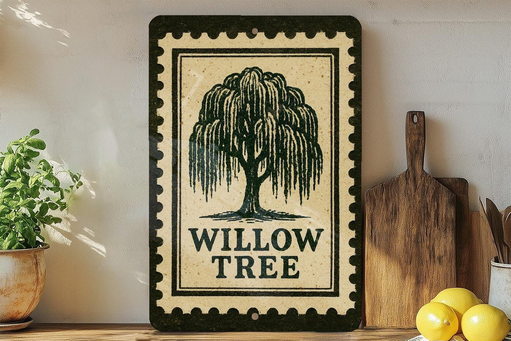a decorative sign with a willow tree design, placed on a shelf next to a wooden cutting board and some kitchen utensils.