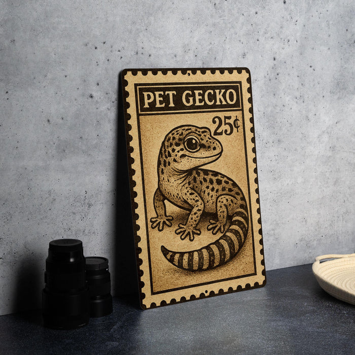 A metal sign featuring a gecko illustration and the text "PET GECKO 25¢" is displayed on a table.