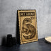 A metal sign featuring a gecko illustration and the text "PET GECKO 25¢" is displayed on a table.