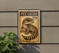 A sign featuring a gecko, which appears to be a pet gecko, mounted on a wall.