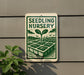 a sign for a "Seedling Nursery" with a plant illustration on it, mounted on a wall next to a plant.