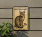 a stamp-like sign with an illustration of a cat, mounted on a wall.