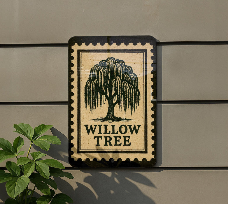 a sign with the text "WILLOW TREES" and a tree illustration, mounted on a wall next to a plant.