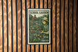 A green and white postage stamp featuring a woman tending to a garden, with the text "SCHOOL GARDEN USA FOREVER" printed on it.