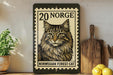 A wooden shelf displaying a framed image of a Norwegian forest cat, a postage stamp, and some kitchen utensils.