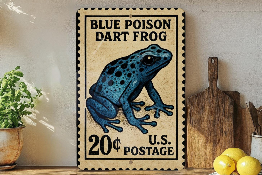 A vintage-style postage stamp featuring a blue poison dart frog, with the text "BLUE POISON DART FROG" and "20¢ POSTAGE" printed on it. The stamp is displayed on a wooden surface, with a potted plant, a wooden cutting board, and some lemons nearby.