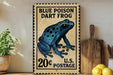 A vintage-style postage stamp featuring a blue poison dart frog, with the text "BLUE POISON DART FROG" and "20¢ POSTAGE" printed on it. The stamp is displayed on a wooden surface, with a potted plant, a wooden cutting board, and some lemons nearby.