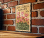 A vintage-style metal sign with a floral design hangs on a brick wall, displaying the text "CYCLAMEN GARDEN 50c".