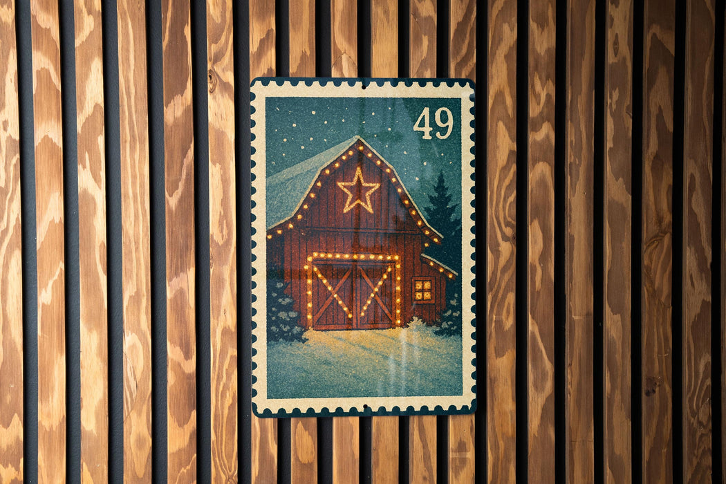 A Christmas-themed postage stamp depicting a wooden barn with a star on the roof, surrounded by lights and a snowy landscape.