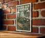 A raised bed garden sign is displayed on a brick wall, featuring an illustration of a raised garden bed with plants and tomatoes.