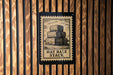A sign with the text "HAY BALE STACK" is displayed on a wooden wall.
