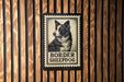 A black and white border stamp featuring a close-up of a Border Sheepad dog.