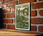 A metal sign with a stamp-like design hangs on a brick wall, depicting a young girl tending to a garden with tomatoes.
