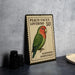 A metal stamp featuring a colorful illustration of a peach-faced lovebird, with the text "Peach-faced Lovebird 50" and "Agapornis Roseicolis".