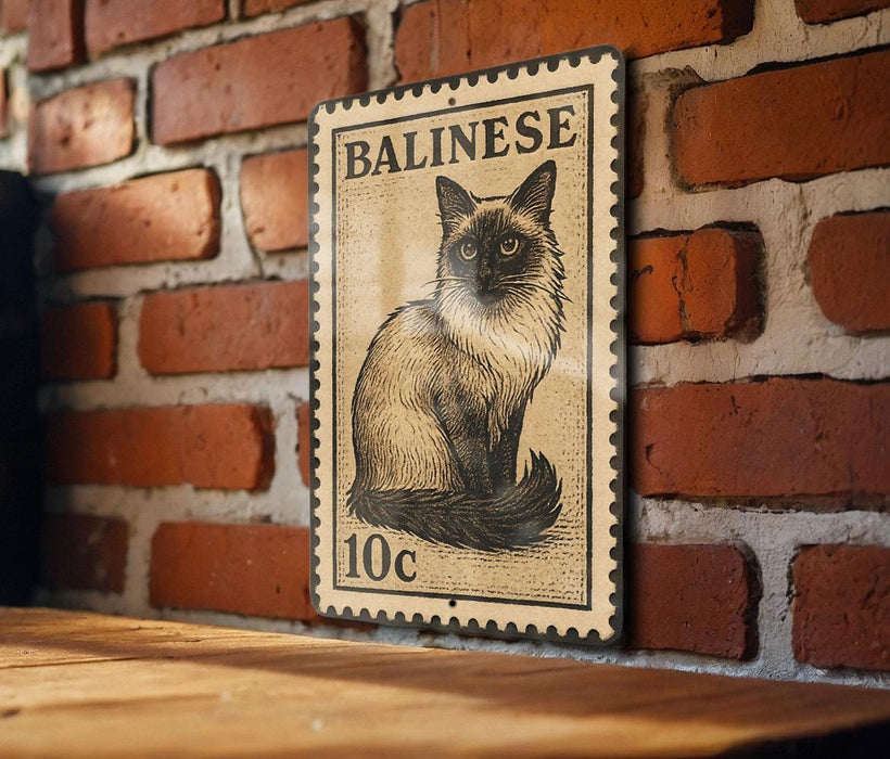A metal sign featuring a cat illustration is mounted on a brick wall.