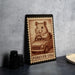 A metal stamp featuring a cartoon image of a hamster sitting in a car, with the text "FREVER USA" printed on it.