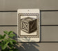 a white sign with a black and white illustration of a wooden crate or box, mounted on a wall.