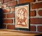 a small, wooden table with a black and white stamp-like artwork depicting a hamster running on a wheel.
