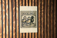 A sign with the word "DUCKLINGS" and an illustration of three ducks is mounted on a wooden wall.