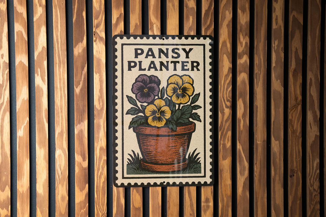 A metal sign with a potted plant and the text "PANSY PLANTER" is displayed on a wooden wall.