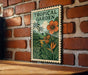 A tropical garden-themed poster is displayed on a brick wall, featuring a lush green landscape with palm trees, flowers, and a large orange flower.