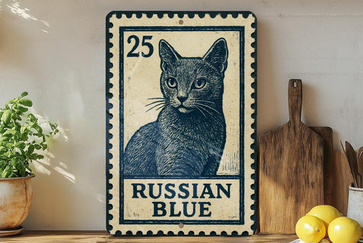 A vintage-style metal sign with a cat illustration, featuring the text "Russian Blue" and the number "25" on it, is displayed on a shelf next to a wooden cutting board and some potted plants.