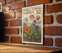 a vintage-style metal sign with a floral illustration, mounted on a brick wall.