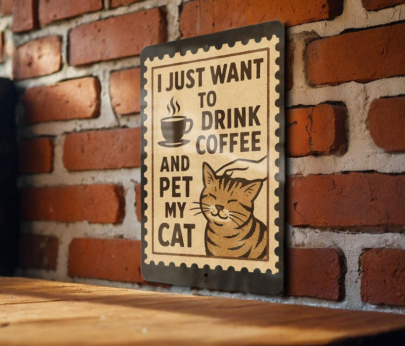 A sign with a cat and the text "I JUST WANT TO DRINK COFFEE AND PET MY CAT" is displayed on a brick wall.