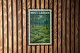 A framed poster of a lush, green forest scene is displayed on a wooden wall.