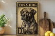 A vintage-style metal sign featuring a black and white illustration of a dog, with the text "TOSA DOG" prominently displayed. The sign is placed on a wooden surface, with a potted plant and a wooden cutting board visible in the background.