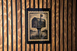 a black and white illustration of a mailbox on a wooden wall.