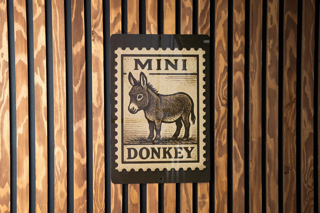 a sign with a donkey illustration on it, mounted on a wooden wall.