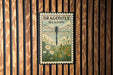A framed poster of a dragonfly is displayed on a wooden wall.